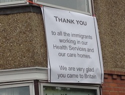 Banner saying thank you to all the immigrants working in our health services and our care homes. We are very glad you came to Britain.