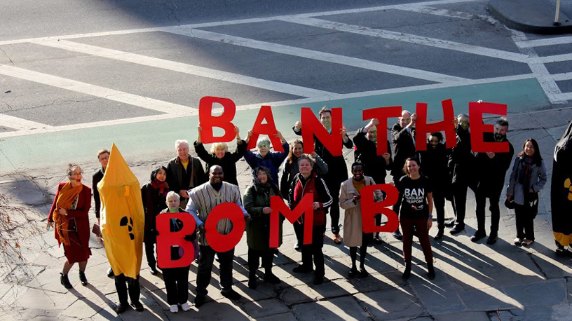 people hold red letters saying ban the bomb
