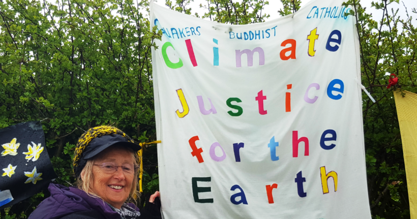 Hilary Whitehead, a Quaker and co-founder of Lancashire's No Faith in Fracking group, holds an interfaith banner. Photo: BYM