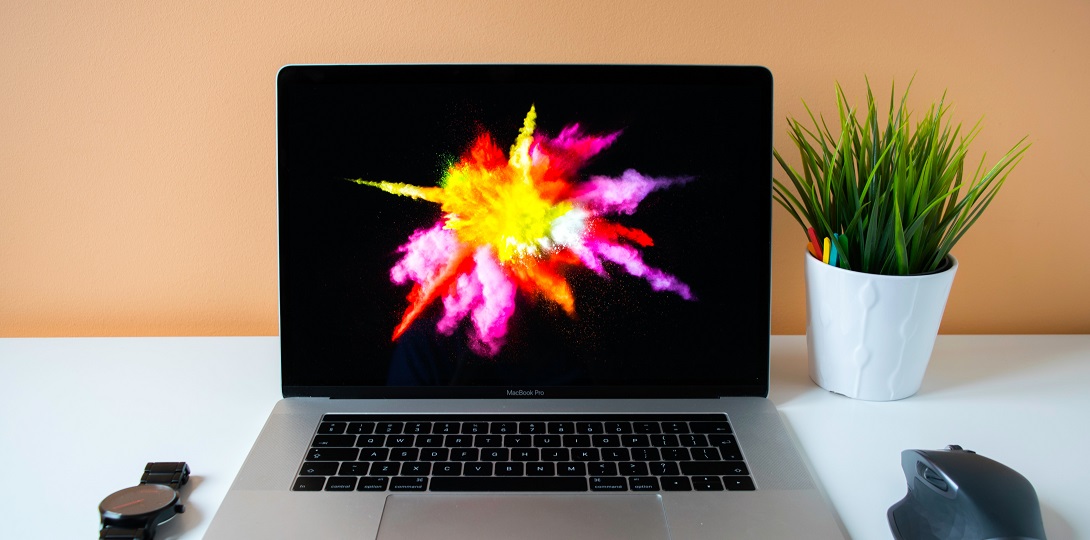 A photograph of a laptop showing an image of a burst of light