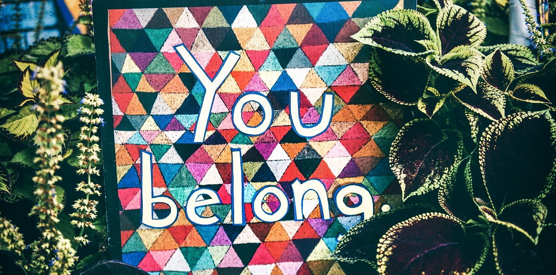 A photograph of a tapestry with the words you belong