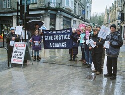 Quakers standing in High Street with flyers about inequality