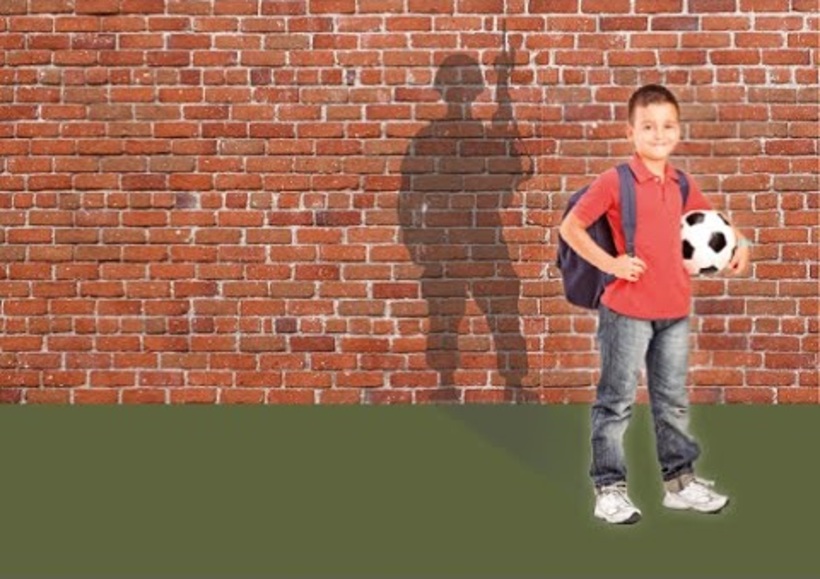 Schoolboy standing with a soldier shadow