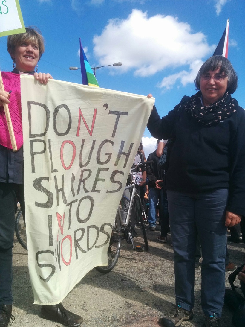 Anna Botwright and a Friend hold a "Don't plough shares into swords" banner at the stop the Arms Fair Demonstration.
