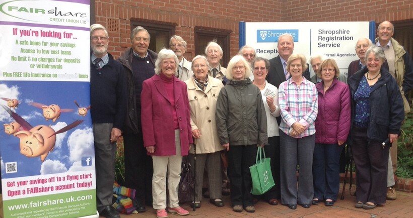 Group of Quakers stood outsied locak credit union building