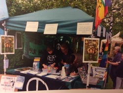 two people in a stall with peace banners