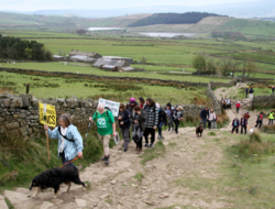 A group of people ascending Pendle Hill