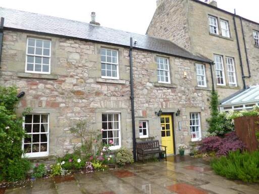 Georgian simple town house with yellow door.