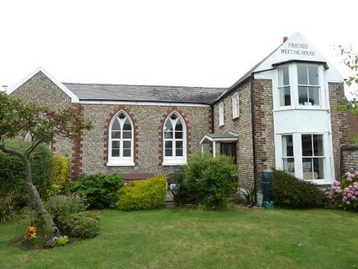 Former school covered flintwork elevation and well-detailed Gothic windows.