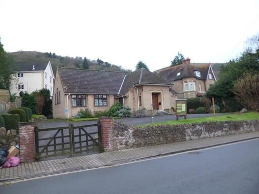 Neo-Georgian domestic style building with a tiled roof and casement windows.