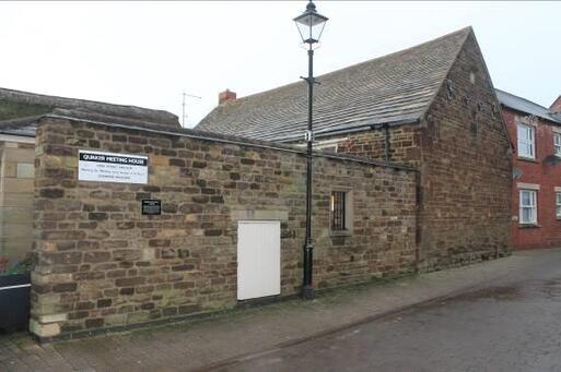 Handsome simple single-storey building with central paneled timber double door.