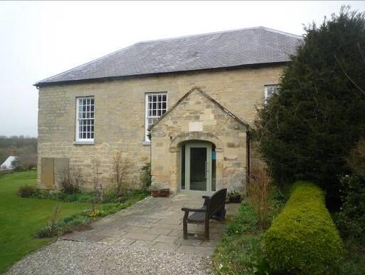 Substantially intact single-storey meeting house stone built with three big windows.