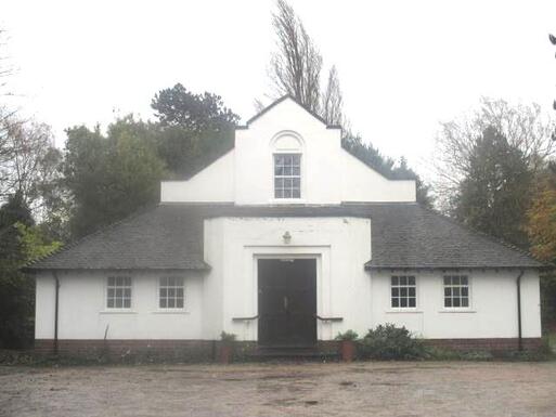 Domestic white Neo-Georgian design house with black roof.