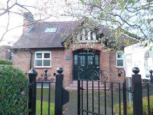 Attractive former mission hall with hedged garden contains some specimen trees.