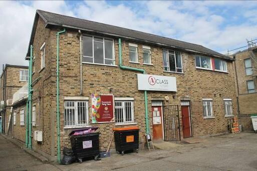 Situated at the back of street building painted walls of yellow stock brick.