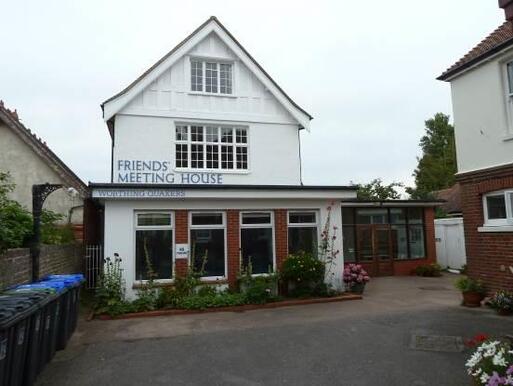 Meeting house converted garage and a boathouse with a blue sign'Friends Meeting House'.