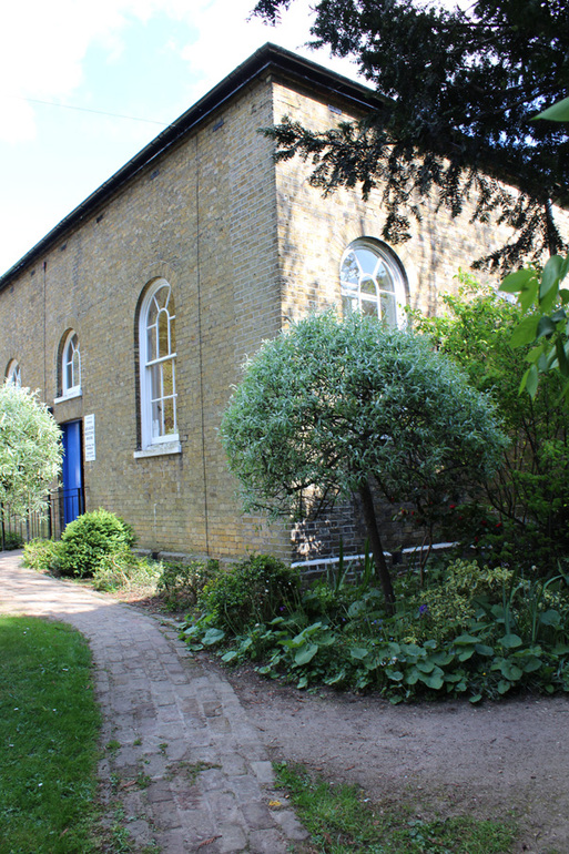 Brick building with a blue door.