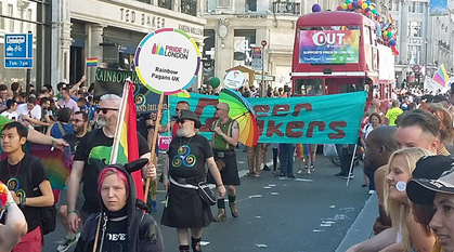 a group of Quakers at Pride in London standing in front of a banner saying Queer Quakers