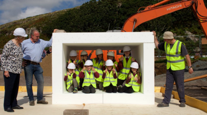 Children celebrate the beginning of a building project in Scotland