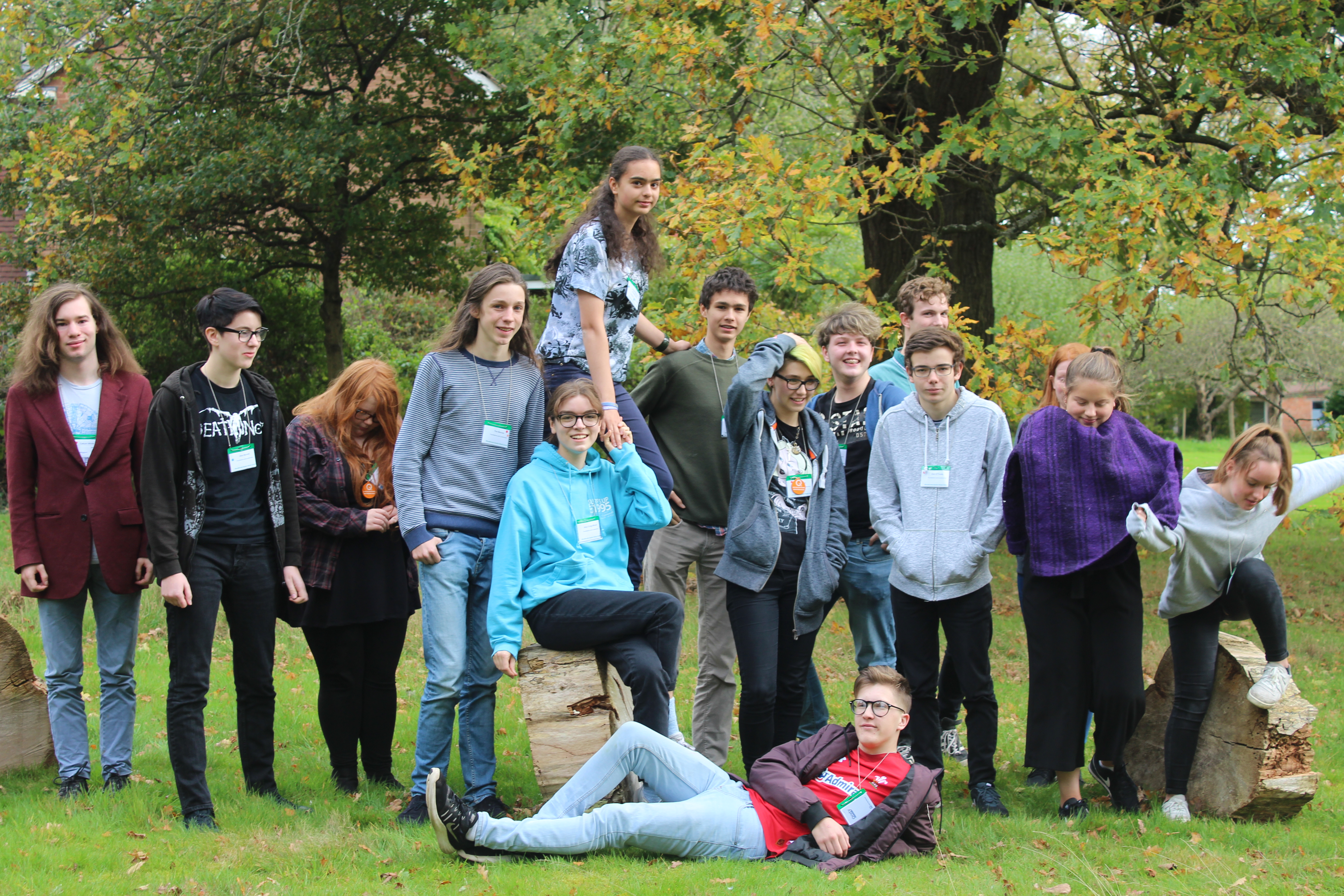 Group of young people posing in a garden in autumn