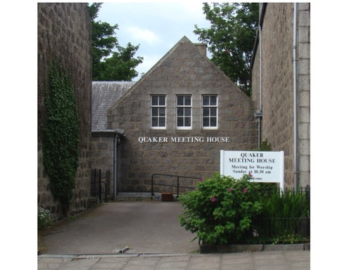 Stone building with words 'Quaker Meeting House' sign. 