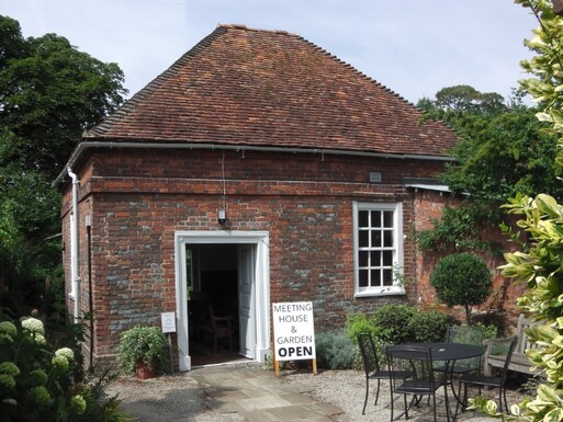 Small brick building in gardens.