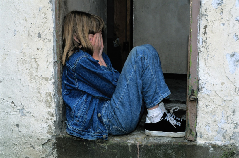 child sitting in cramped doorway
