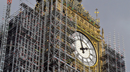 Close-up of one side of the clockface of Elizabeth Tower (Big Ben) surrounded by scaffolding