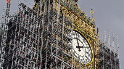 Close-up of one side of the clockface of Elizabeth Tower (Big Ben) surrounded by scaffolding