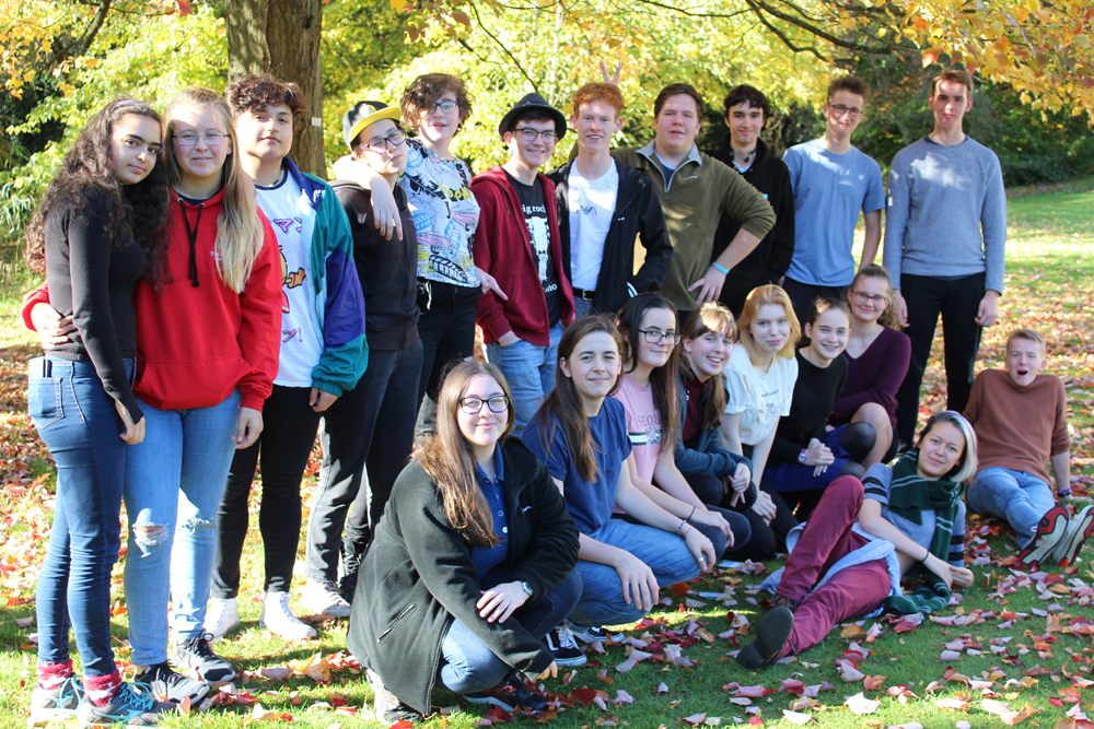 Group of young people under an autumnal tree