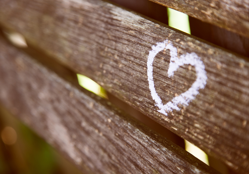 heart carved on wooden bench 