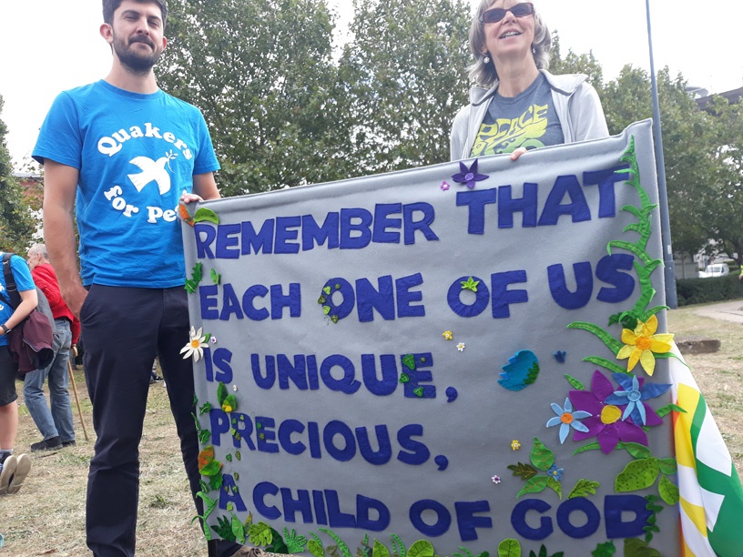banner says each of us is a precious child
