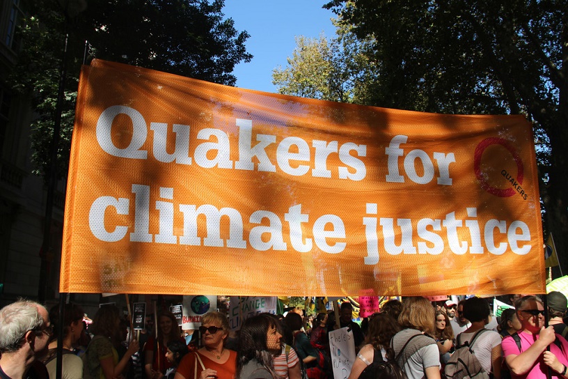 orange banners says Qs for climate justice