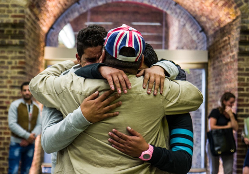 three people in emotional hug