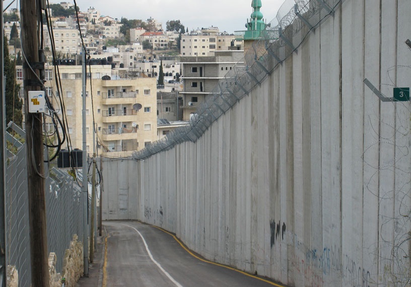 massive concrete wall runs through community