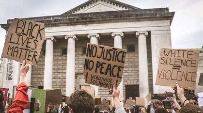 Close up of three placards from a UK Black Lives Matter protest. The three placards say 'Black Lives Matter'; 'No Justice, No Peace, Worldwide Solidarity'; White silence = violence'