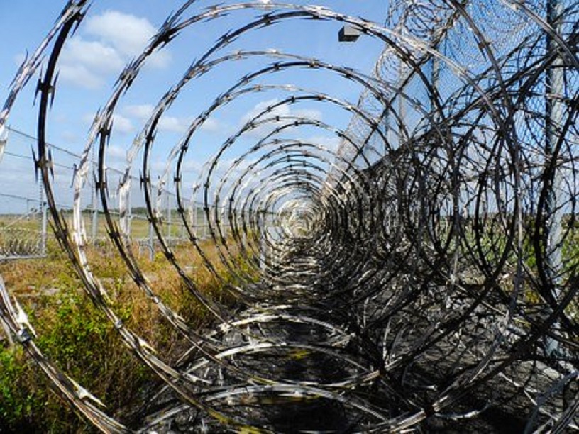 massive reels of razor wire encircle prison