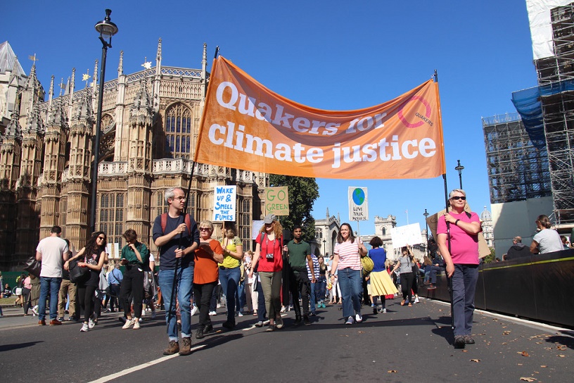 Crowds follow orange banner on climate justice
