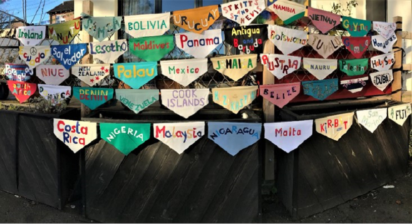 colourful embroidered pennants naming countries ratified