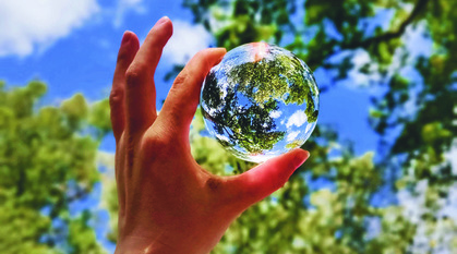 Hand holding a glass globe