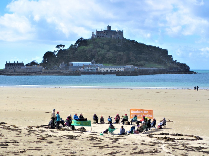 circle of seated Qs on beach near St Michael's Mount