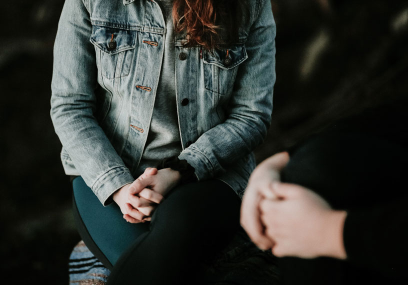 two people with their hands on their laps