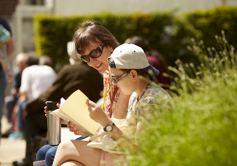 smiling woman and girl reading