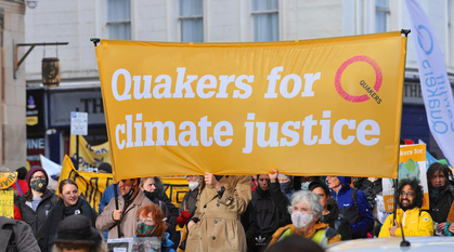 Quakers marching with a banner saying Quakers for climate justice
