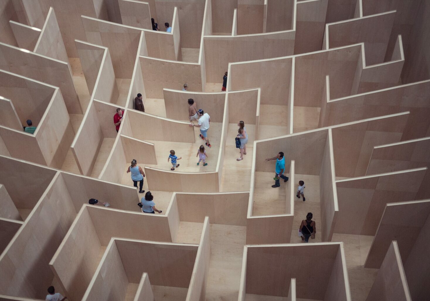 Image with a maze and people walking in it