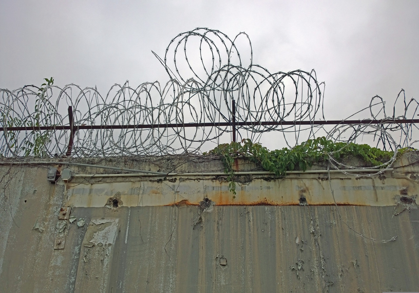 razor wire above concrete wall