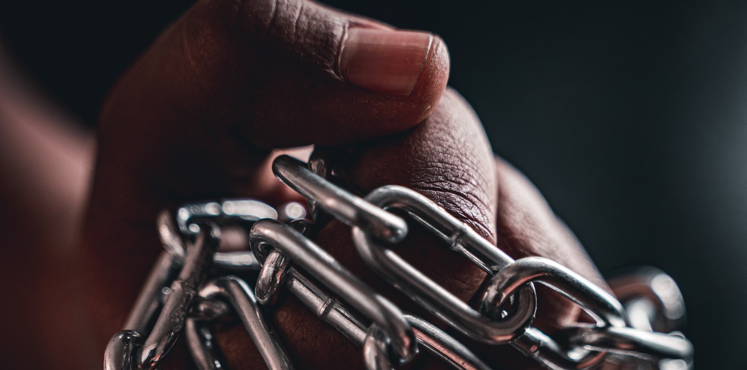 A hand holding chains