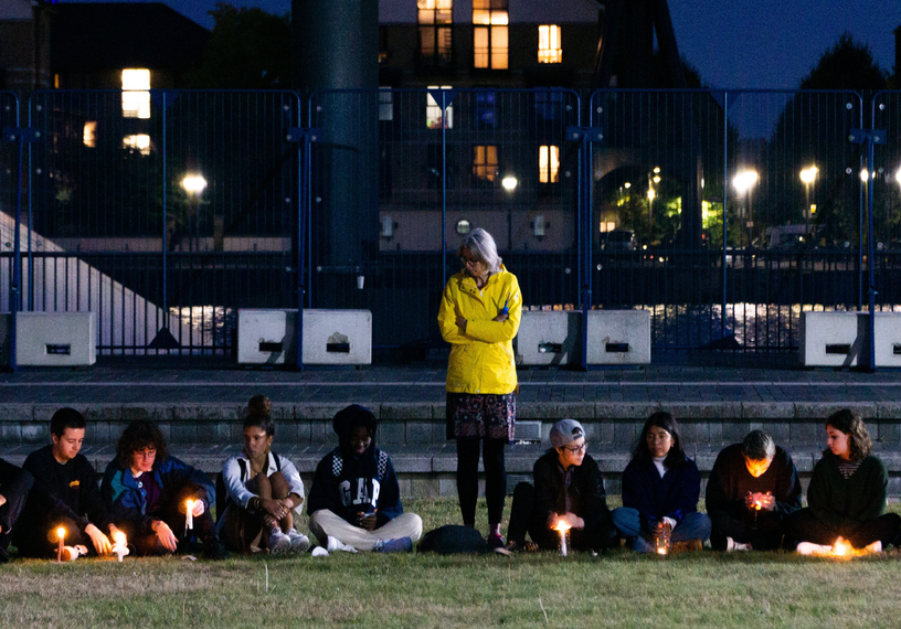 young people sitting outside in dark