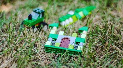 Lego toys laying in grass