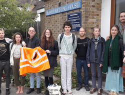 A group of people standing outside a meeting house